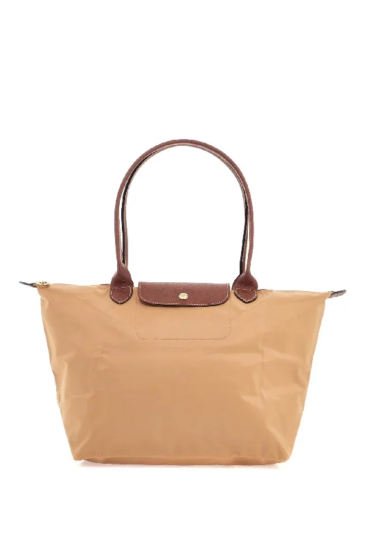 Monogrammed Tote Bag in Brown Leather with Personalized Initials for a Custom and Elegant TouchGeometric - Printed Tote Bag in Multicolor for a Contemporary and Trendy OutfitLongchamp Le Pliage Original L Tote Bag